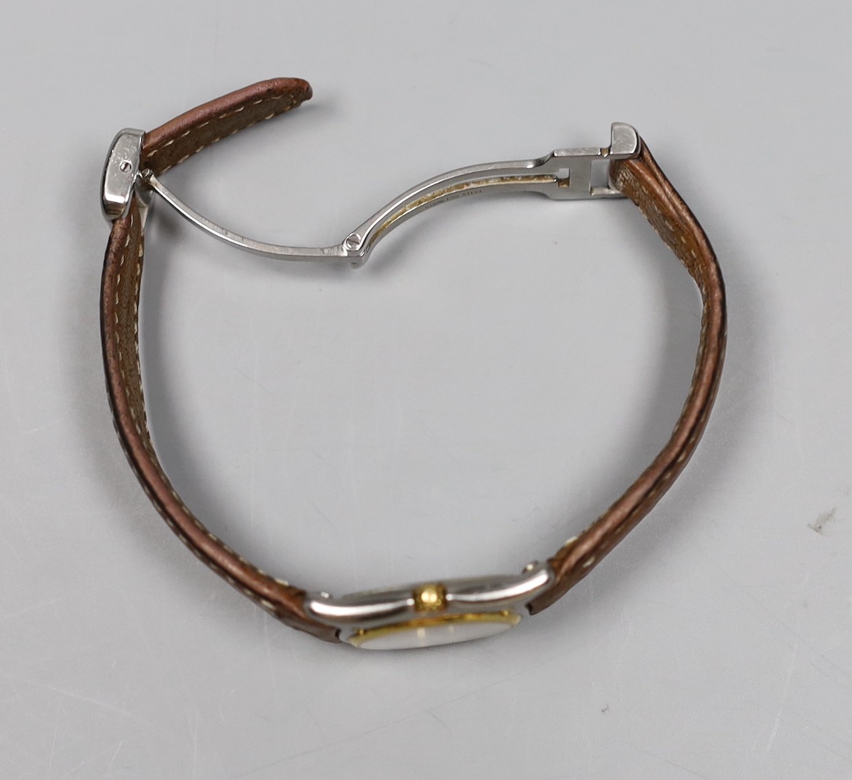 A lady's 18K and steel Ebel 1911 quartz wrist watch, on a leather strap with steel deployment clasp, no box or papers.